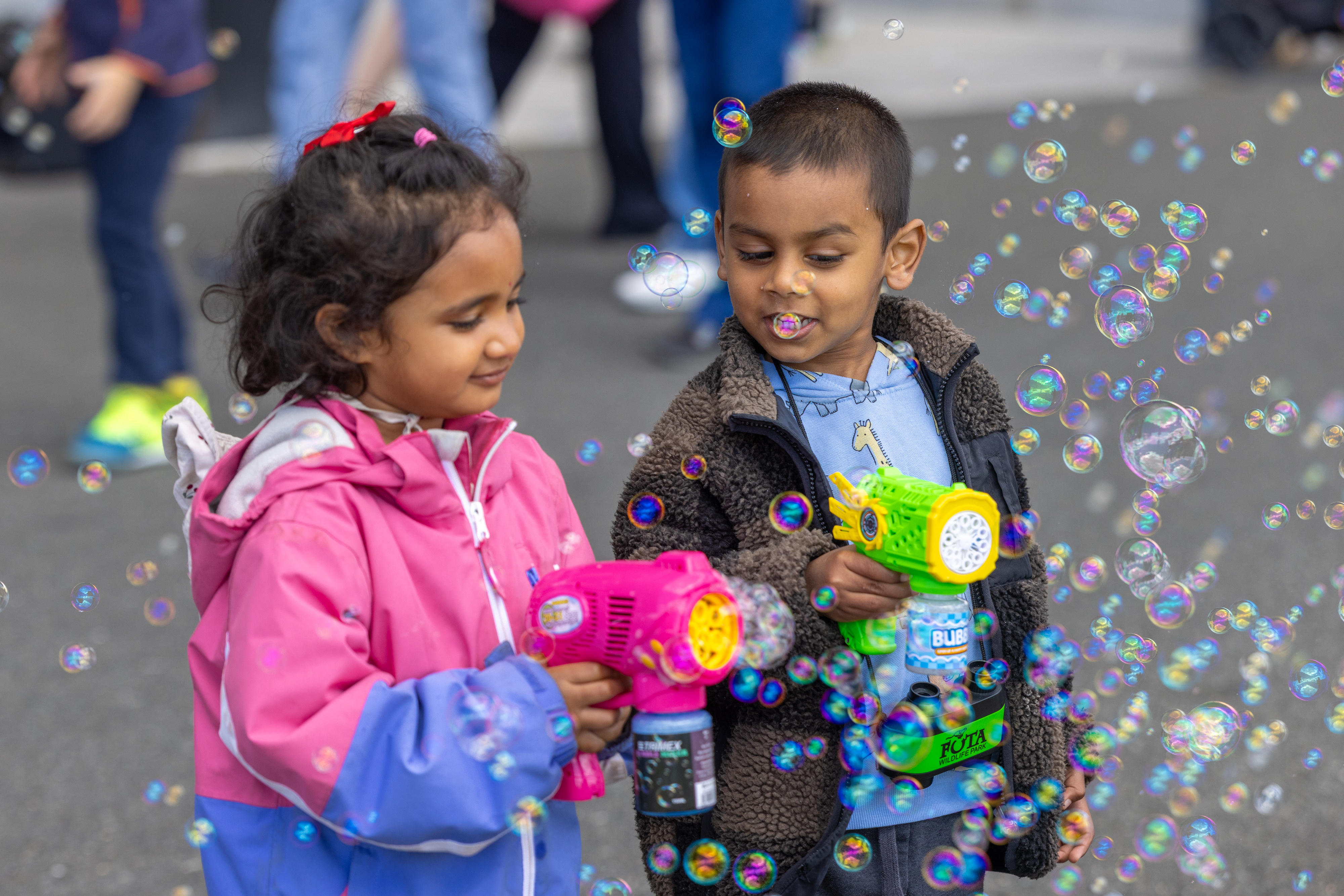 Two children playing with bubbles. 